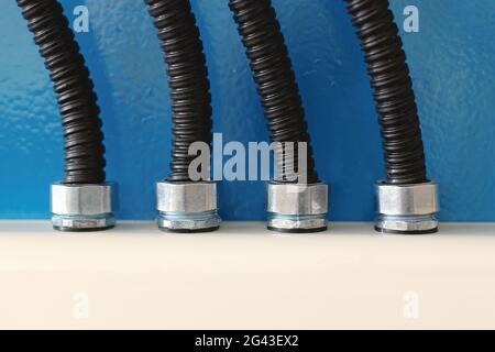 The electrical wires in the corrugated protection are attached to the cable duct by means of nuts. Stock Photo