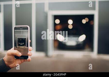 USA - New York, March 19, 2019: The new modern Mercedes Benz AMG GLE 63 S 4MATIC in dealership salon with mobile phone iPhone in Stock Photo