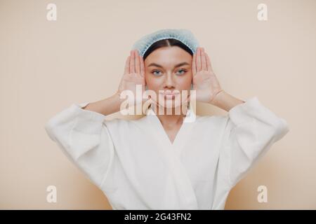 Young woman doing face building facial gymnastics self massage and rejuvenating exercises Stock Photo