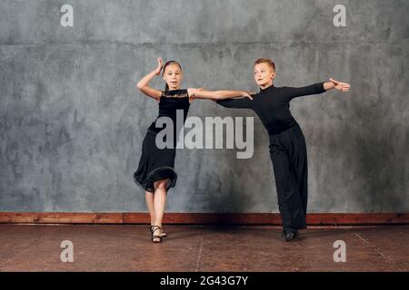 Young couple boy and girl dancing in ballroom dance Jive Stock Photo