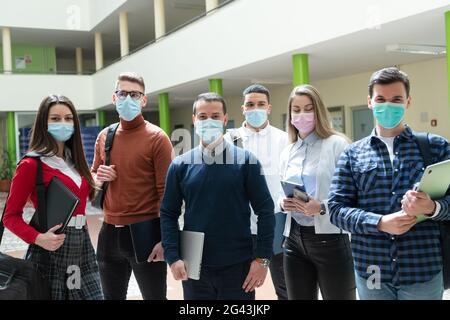 Multiethnic students group wearing protective face mask Stock Photo