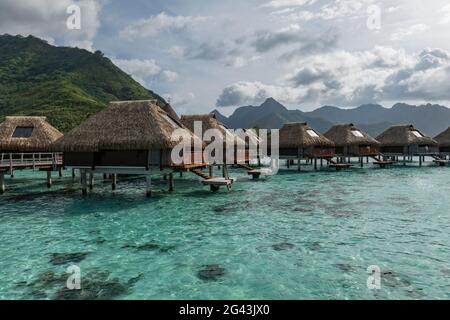 Overwater bungalows at the Hilton Moorea Lagoon Resort & Spa, Moorea, Windward Islands, French Polynesia, South Pacific Stock Photo