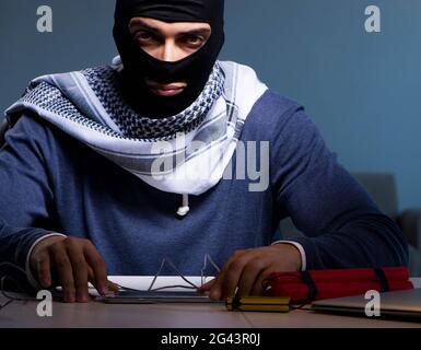 Terrorist bomber preparing dynamite bomb Stock Photo