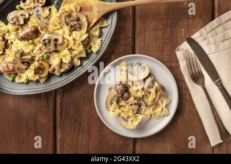 Mushroom and cheese pasta. Farfalle with cremini and green peas