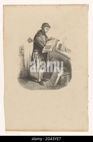 Bookseller with opened book. Interior of a bookstore with books on the floor and in the windowsill. The bookseller holds a slightly opened book, and has clamped a plumeau under his arm. Stock Photo