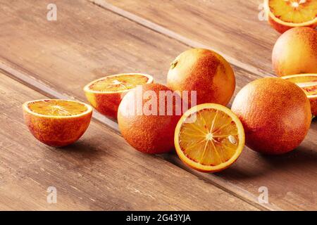 Organic blood oranges on a dark rustic background Stock Photo