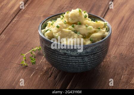 Pomme puree, a photo of a bowl of mashed potatoes with herbs Stock Photo