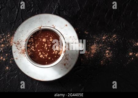 Hot chocolate in a cup with cocoa powder, shot from above with a place for text Stock Photo