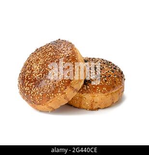 Two baked sesame seed buns isolated on white background, hamburger bread Stock Photo