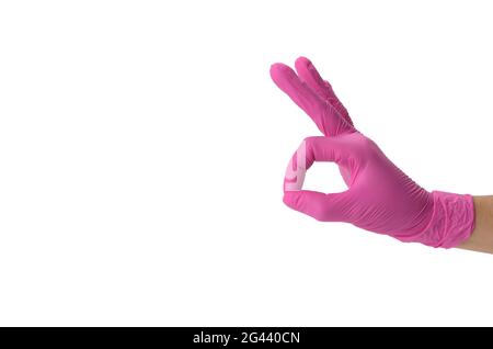 Hand in pink medical glove shows ok gesture, white backgroundc Stock Photo