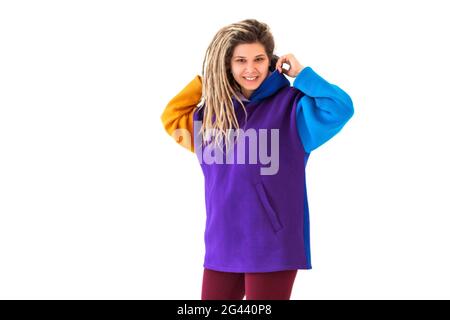 Happy woman shaking dreadlocks and smiling Stock Photo