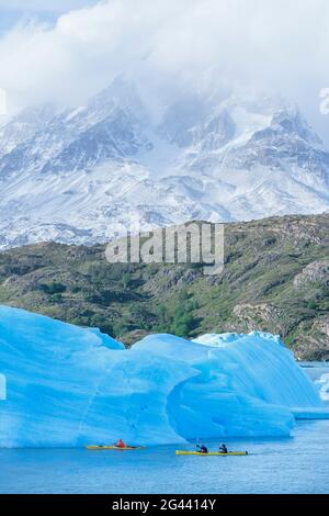 Kayakers paddles among icebergs, Torres del Paine National Park, Patagonia, Chile, South America Stock Photo