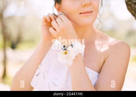 Beautiful tender bride put an earring in her ear Stock Photo