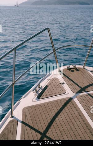 Close up view of the bow of a white yacht sailing on the blue sea Stock Photo
