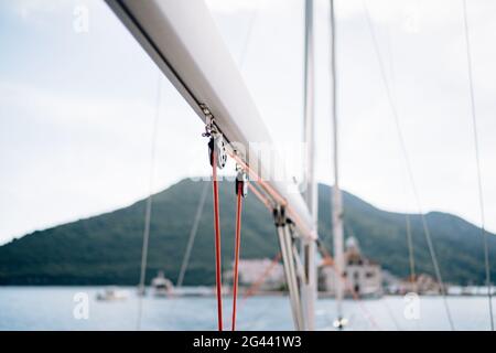 Winch of white sailing yacht with a red rope on a background of mountains Stock Photo