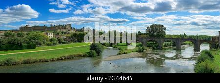 Landscape with old arch bridge across Aude River, Carcassonne, Occitanie, France Stock Photo