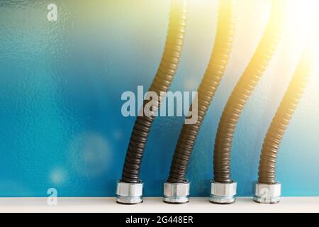 The electrical wires in the corrugated protection are attached to the cable duct by means of nuts. Stock Photo