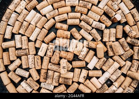 Budva, Montenegro - 21 august 2020: Circle made of wine corks from wine bottles on wooden texture. Stock Photo