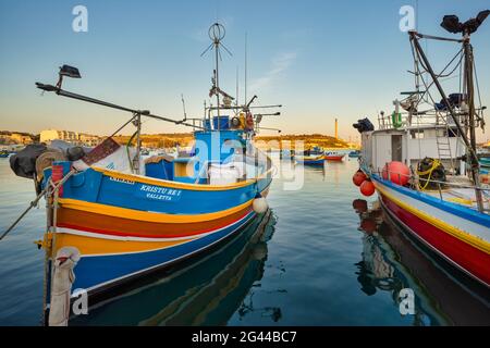 Colorful fishing boats lie in the harbor at Marsaxlokk, Malta, Europe Stock Photo