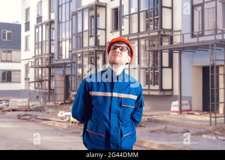 portrait of worker in helmet doing job on construction site Stock Photo