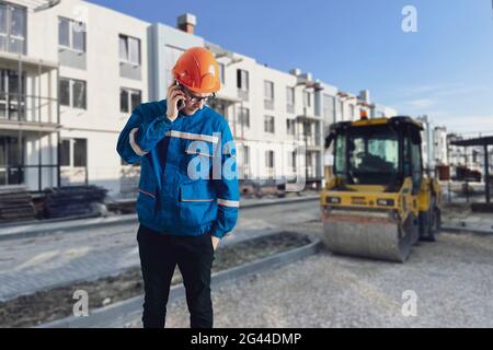 portrait of worker in helmet doing job on construction site Stock Photo