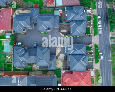 Drone aerial view of Brick Veneer town houses in Melbourne Victoria Australian Suburbia. Rood design of residential town houses in Suburban Melbourne Stock Photo
