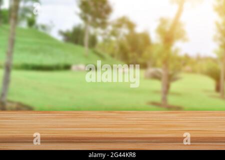 Empty wood table top over blur green nature background for product display or montage. Stock Photo