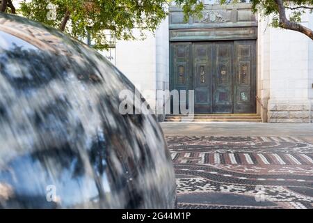 Rotating blurred rock sphere in Forrest Chase with historic doorway. Stock Photo