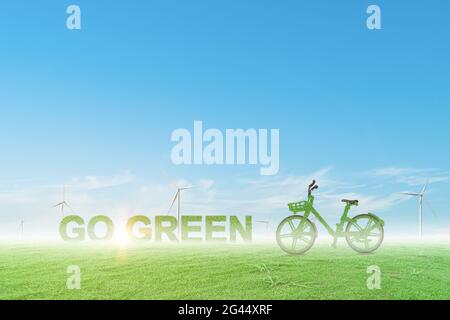 Green bicycle and globe on wind turbine field with blue sky background ...