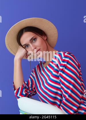 Portrait of young woman sitting on the chair Stock Photo