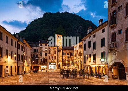 Evening view of Piazza Flaminio in the Serravalle district in Vittorio Veneto, in the background the Civic Tower and the Community Palace. Veneto regi Stock Photo