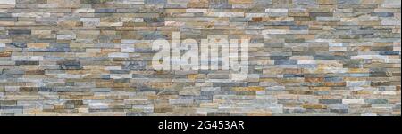 New panoramic wall made of colored facing stones Stock Photo
