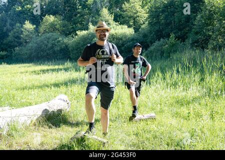 Berlin, Germany. 14th June, 2021. Christian Gollwitzer (l) stands with a hiking friend on a meadow in Grünau. (to dpa: 'Lonely times over: Corona trend hiking becomes more sociable') Credit: Paul Zinken/dpa-Zentralbild/dpa/Alamy Live News Stock Photo