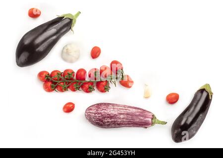 A flat lay composition with vegetables. Eggplants, tomatoes, and garlic, shot from above Stock Photo