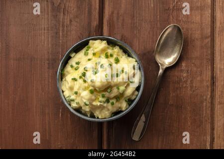 Pomme puree, a photo of a bowl of mashed potatoes with herbs, shot from the top