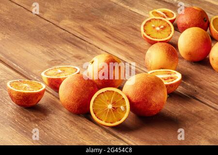 Fresh organic blood oranges on a dark rustic wooden background Stock Photo