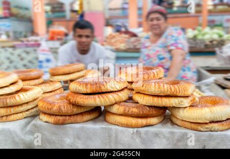 Khujand/Tajikistan-05.18.2020:The view of stall full of traditional tajik round wheat baked bread in bazaar in Tajikistan Stock Photo