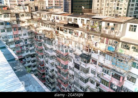 The popular between tourists place called Montane Mansion near to Tai Koo in Hong Kong. Overcrowded old retro building Stock Photo