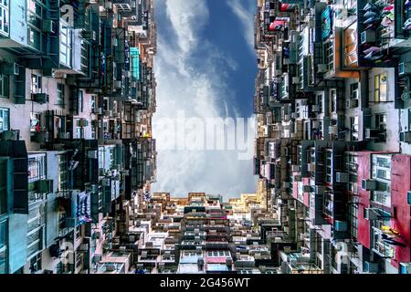 The popular between tourists place called Montane Mansion near to Tai Koo in Hong Kong. Overcrowded old retro building Stock Photo