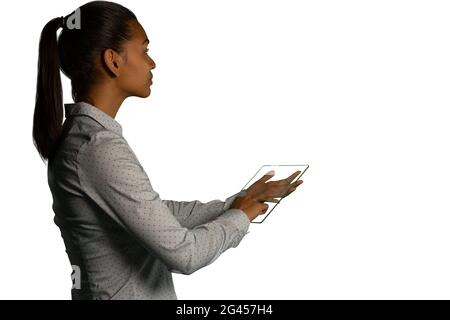 Businesswoman holding a transparent portable device Stock Photo