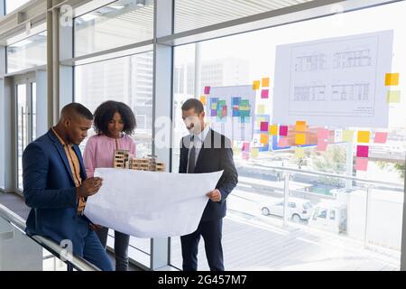 Three young architects working together Stock Photo