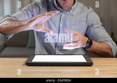 Young man using tablet computer on a table Stock Photo
