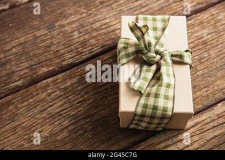 Simple wrapped gift on wooden table Stock Photo