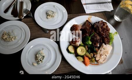 International Food Buffet all you can eat smorgasbord table by the window five star hotel restaurant in Bangkok Thailand Stock Photo