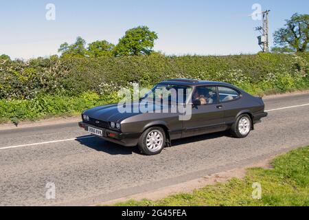 1984 80s, eighties Brown Ford Capri Ls 4spd 1593cc petrol hatchback  en-route to Capesthorne Hall classic May car show, Cheshire, UK Stock Photo