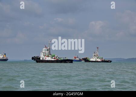 Tugboat sailing in the sea. Tugboat making maneuvers, Tanjung Pinang Riau Islands Stock Photo