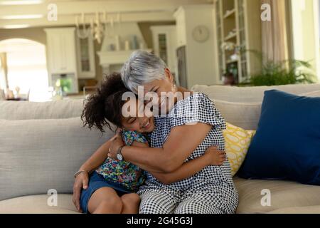 Senior mixed race woman with her granddaughter at home Stock Photo