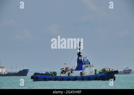 Tugboat sailing in the sea. Tugboat making maneuvers, Tanjung Pinang Riau Islands Stock Photo