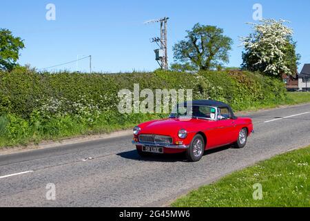 1962 60s red MG Roadster two-door sports car 1800cc petrol cabrio,  en-route to Capesthorne Hall classic May car show, Cheshire, UK Stock Photo