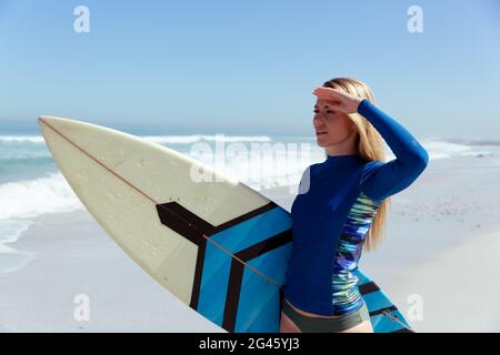 Caucasian woman during surf session at beach Stock Photo